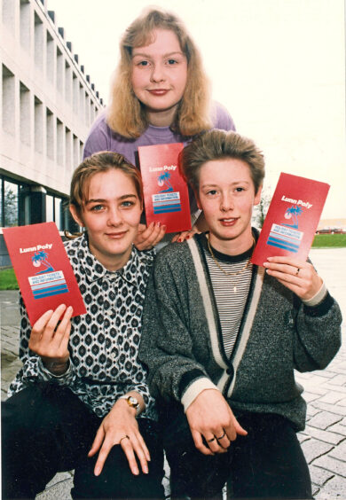 Three pupils holding tickets