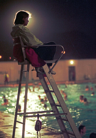 1995 - Lifeguard Kirsten Sinclair, 17, keeps watch on midnight swimmers at the open air pool in Stonehaven.