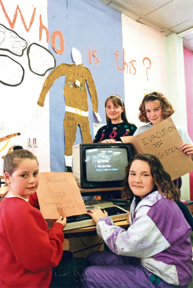 Four Dyce schools pupils working on a computer