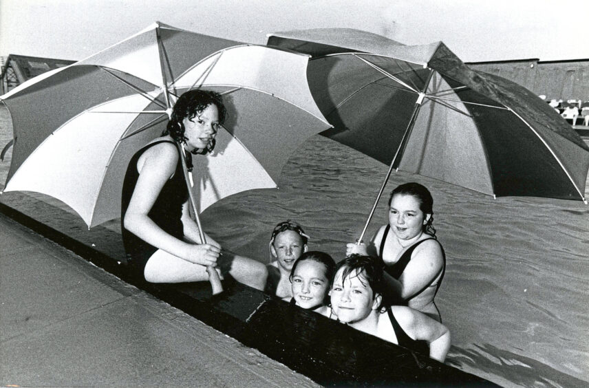 1990 - Umbrellas were also necessary swimming gear for Laura Moffat, David Scott, Lynne Reid, Dawn Reid and Maureen Cargill