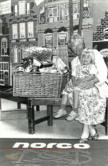 1992 - Roberta Crawford with grand-daughter Rachel Walker, 2, and their food hamper prize after winning the Norco Going Dutch competition.