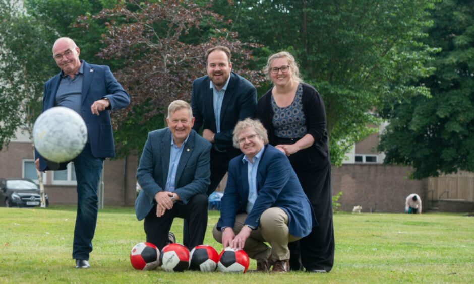 Aberdeen FC legend Willie Miller with council co-leaders Alex Nicoll (left) and Ian Yuill (right). Finance convenor Alex McLellan and operations convener Miranda Radley keep their eye on the ball behind them. Image: Aberdeen City Council.