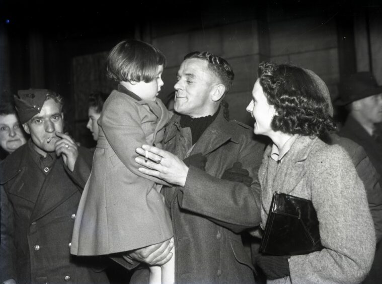 Prisoner of war is reunited with his family in 1943.