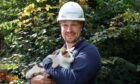 Openreach engineer Doug Craig discovered stowaway Tia after he finished a job in Coll. Image: Openreach/PA