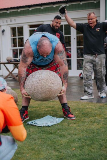 Strongman Andy Black lifting the Invercauld stone