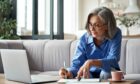 Woman sits down to prepare the paperwork needed for her retirement