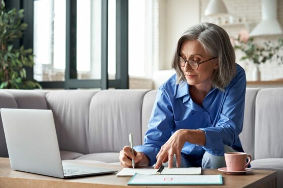 Woman sits down to prepare the paperwork needed for her retirement