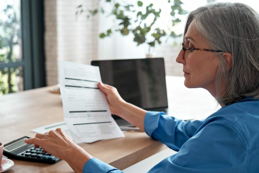 Woman makes calculations to prepare for her retirement