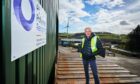 Owner of Pi Polymer Recycling proudly poses in front of his enterprise