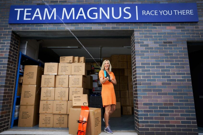 Team Magnus owner Kristine Moody happily poses with her inventory