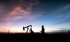 worker at crude oil pump in oilfield