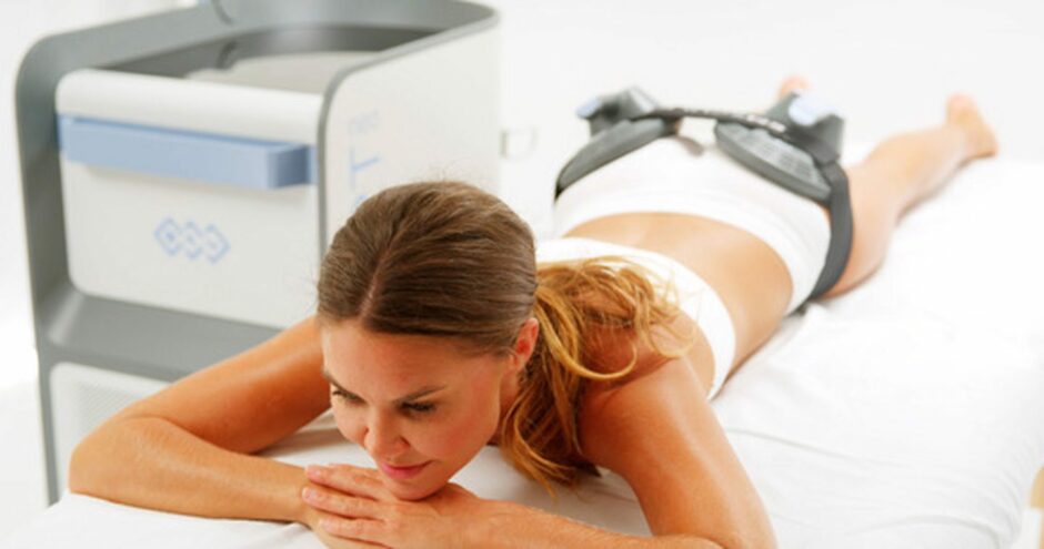 woman lies on her tummy to tone her bottom with the Emsculpt NEO treatment