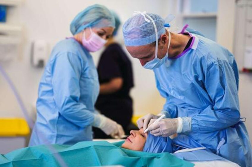 medical professionals carry out a procedure on a client 
