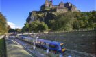 ScotRail train passes Edinburgh Castle