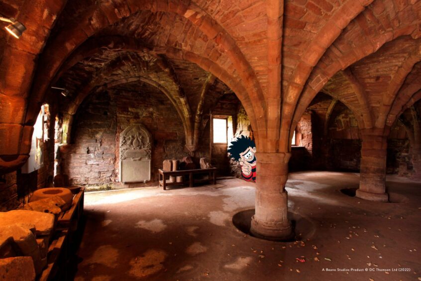 Dennis hides behind a column inside Arbroath Abbey