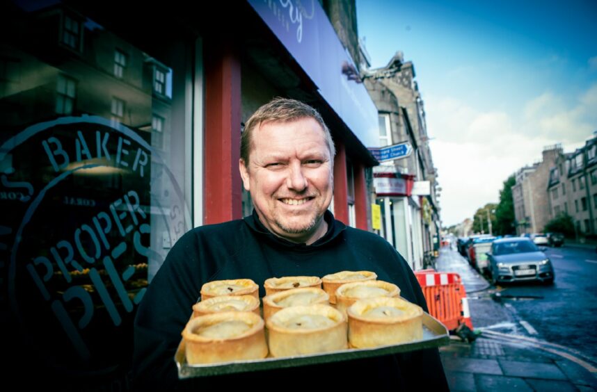 Thain's owner Paul Allan holding some Pittodrie Pies outside his George Street bakery