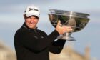 Ryan Fox lifts the trophy after winning the Dunhill Links.