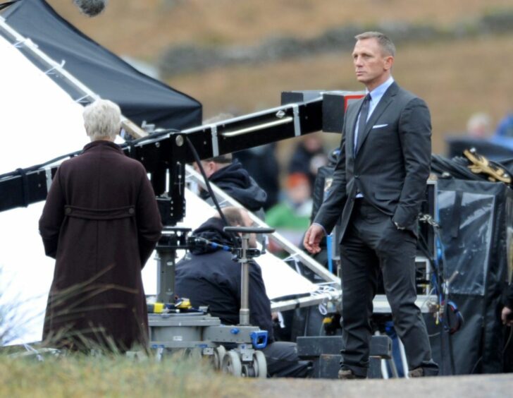 Daniel Craig and Dame Judi Dench on set in Glencoe, Scotland.