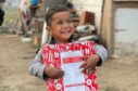 children receiving a Christmas shoebox from Blythswood