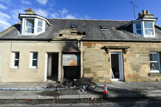 A burned-out section of roof is visible following a fire at a property in Elgin. Image: Jason Hedges.