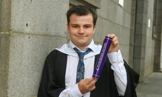 Shay McGillivray with his graduation scroll.
Image: Kenny Elrick.