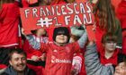 A young fan, whose favourite player is Francesca Ogilvie, cheers Aberdeen Women on at Pittodrie. Images: Kenny Elrick