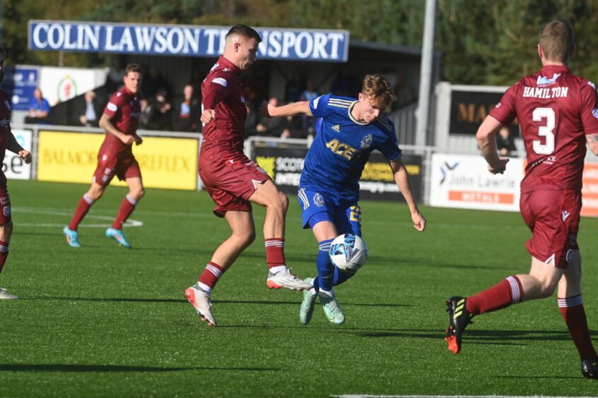 Cove Rangers midfielder Cieran Dunne tries to get away from Arbroath's Dylan Tait. Image: Kenny Elrick/DC Thomson