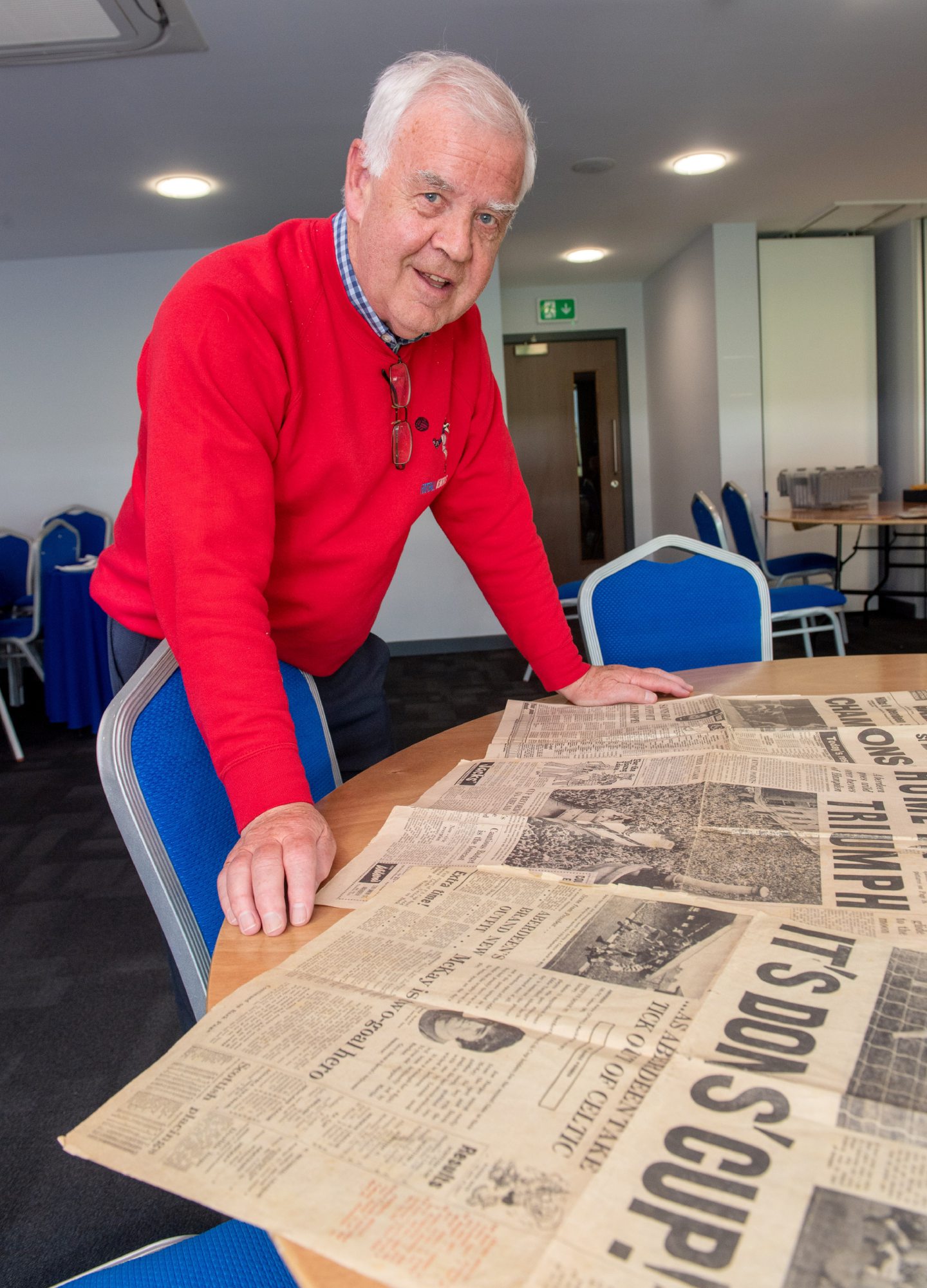 Charlie Craig looks at some old Green Finals at the Football Memories session at Balmoral Stadium, Aberdeen.