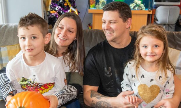Tyler, Jade, Neil and Millie Ritchie. Eight-year-old Tyler is struggling to find the right autism support at school. Image: Kami Thomson / DC Thomson
