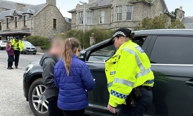 Children confront drivers who have been pulled over by police outside their school
