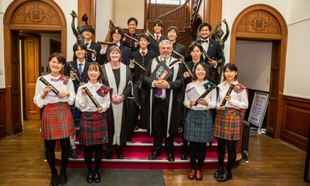 Graduates of the RGU-Nippon Foundation Ocean Innovation Consortium Summer School couldn't leave for home without a kilted graduation ceremony. Supplied by RGU.