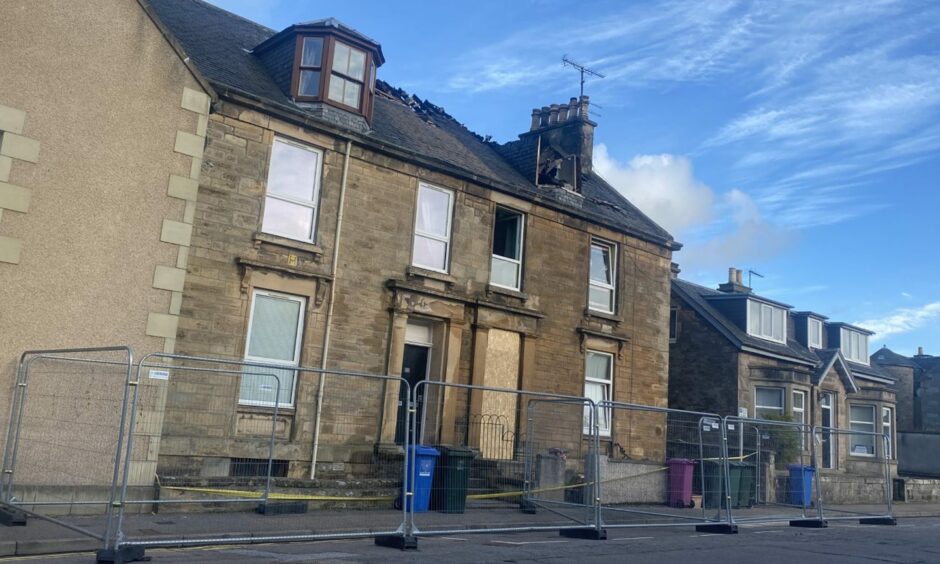 North Guildry Street flats shielded with police tape and fencing as large chunks of the roof are missing and lying before the property 