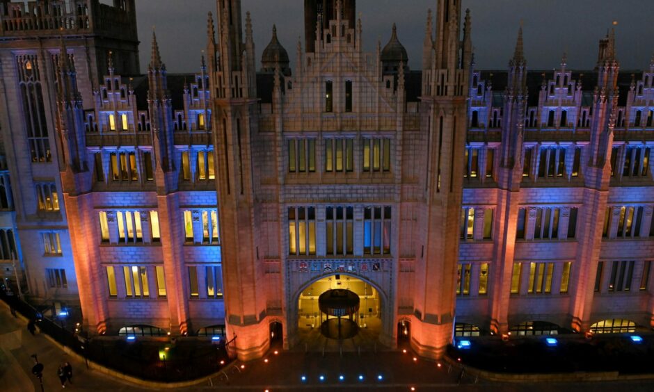 Marischal College lit up in blue and yellow to show solidarity with the people of Ukraine following the Russian invasion. Image: Paul Glendell