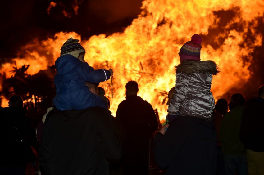 A family watching a bonfire display in Banchory, 2018