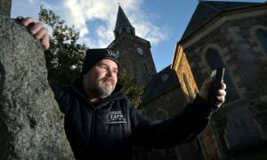 Liam Shand, co-founder of the Highland Paranormal group in the graveyard of the Old High Church in Inverness. Image: Sandy McCook