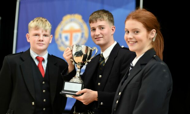Grieg Grierson, who won the W.G.G. Wilson Trophy in the 16-18-year-old pibroch competition, pictured centre, with Logie Johnston, who took third place and Laura Robertson who secured second place. Image: Sandy McCook/ DC Thomson.