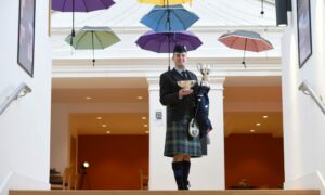 Craig Sutherland, winner of the Premier Grade pibroch piping competition, with the James R Johnston Memorial Trophy and the John T Macrae Cup which he won for the  Premier Grade March Strathspey and Reel. Picture: Sandy McCook/DC Thomson
