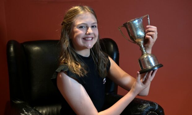 Lily McDowall of South Lochs, Lewis with the John Mackenzie Paterson Memorial Trophy for poetry in the 11-12 category. Image: Sandy McCook/ DC Thomson.