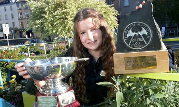 Ellie Johnson of the Sir E Scott School with the Iain Morrison Memorial Trophy and the Charlie MacColl Memorial Trophy for singing in the girls fluent 16-18 age group. Image: Sandy McCook/ DC Thomson.