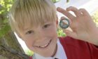 Calum Michael Morrison with his gold badge in the primary seven fluent singing category. Image: Sandy McCook/ DC Thomson.