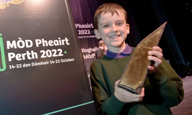 Fionnlagh Macmhaoilein of Inverness with the Tom and Rae Mitchell Memorial Prize for Traditional Singing Boys aged under 13. Image: Sandy McCook / DC Thomson.