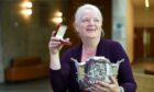 Christine Stone of Castletown, Caithness with the Ailsa Quaich trophy and the Lewis and Harris Medal won in the Literary Awards as part of the Royal National Mod. Image: Sandy McCook/ DC Thomson.