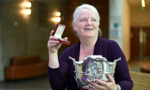 Christine Stone of Castletown, Caithness with the Ailsa Quaich trophy and the Lewis and Harris Medal won in the Literary Awards as part of the Royal National Mod. Image: Sandy McCook/ DC Thomson.