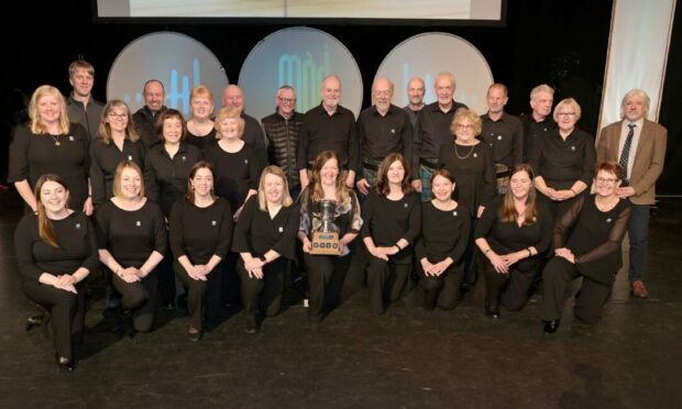 Oban Gaelic Choir, winners of the newly introduced accompanied Choir competition with their conductress Sileas Sinclair. Image: Sandy McCook/ DC Thomson.