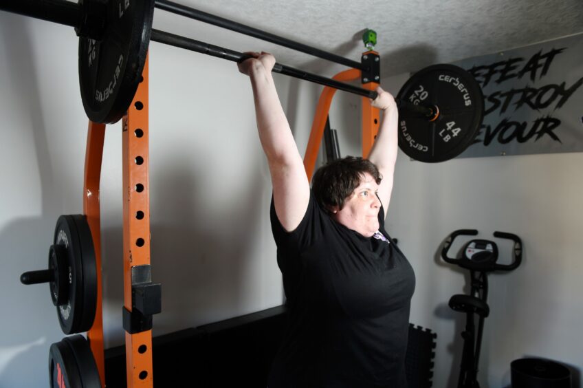 The Moray strongwoman lifting weights at home. 