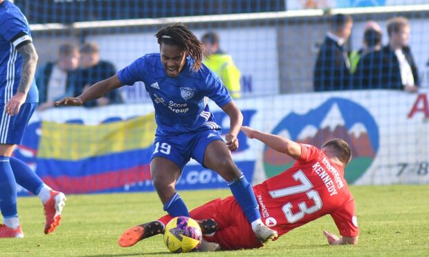 Peterhead's new signing Julien Carre is fouled by Kai Kennedy. Image: Duncan Brown.