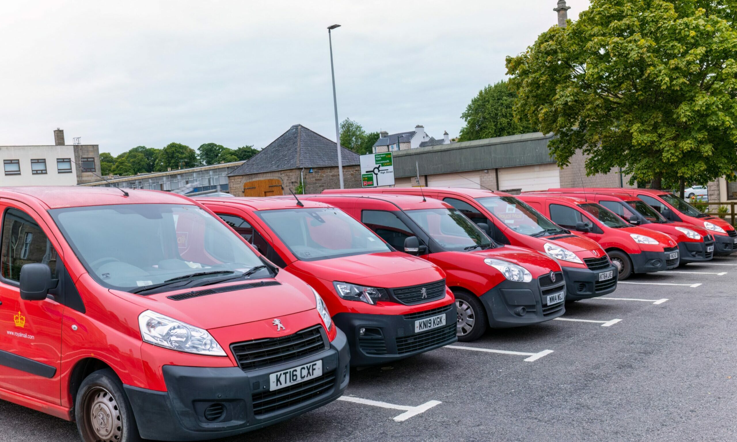 Front of Royal Mail vans in Elgin lined up in a car park. 