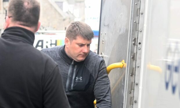 Ramunas Smitras is led to a prison van following his guilty verdict at Aberdeen Sheriff Court.