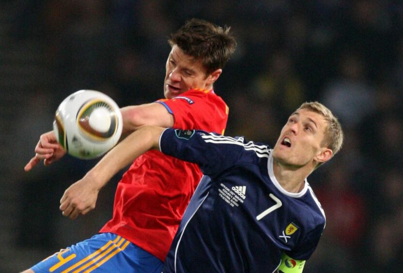 Xabi Alonso and Darren Fletcher in action during a 2012 European Championship qualifier between Scotland and Spain. Image: PA