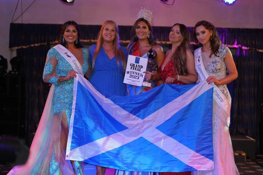 Sarah Patterson holding up Scottish flag with team as she won Miss European 2022